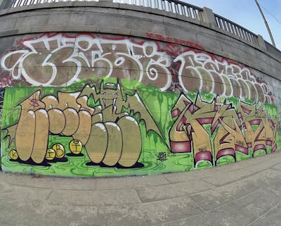 Light Green and Beige Stylewriting by brg crew and Amzer. This Graffiti is located in Uzhhorod, Ukraine and was created in 2023. This Graffiti can be described as Stylewriting, Characters, Throw Up and Wall of Fame.