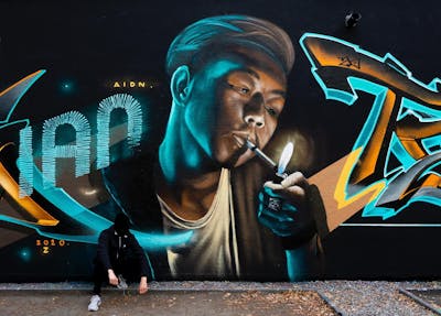 Cyan and Orange Characters by AIDN and New Cru. This Graffiti is located in Berlin, Germany and was created in 2020. This Graffiti can be described as Characters.