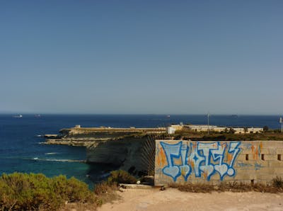 Light Blue and Blue Stylewriting by Riots. This Graffiti is located in Malta and was created in 2013. This Graffiti can be described as Stylewriting and Abandoned.