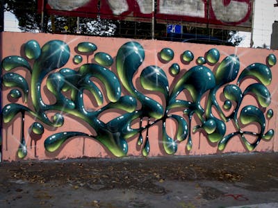 Cyan and Light Green Stylewriting by Kezam. This Graffiti is located in Auckland, New Zealand and was created in 2022. This Graffiti can be described as Stylewriting, 3D and Wall of Fame.