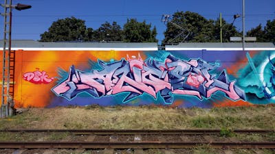 Coralle and Orange and Light Blue Stylewriting by DCK, Angel and ALL CAPS COLLECTIVE. This Graffiti is located in Hungary and was created in 2019. This Graffiti can be described as Stylewriting and Wall of Fame.