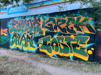 Orange and Green Stylewriting by Fumok, Shari, Greck and Coste. This Graffiti is located in Leipzig, Germany and was created in 2022. This Graffiti can be described as Stylewriting and Wall of Fame.