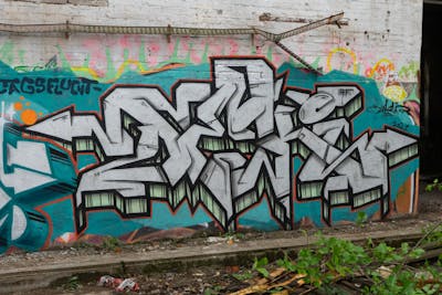 Chrome and Cyan Stylewriting by Deki and AF Crew. This Graffiti is located in Wolfenbüttel, Germany and was created in 2021. This Graffiti can be described as Stylewriting and Abandoned.
