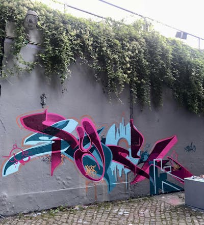Cyan and Coralle Stylewriting by Syck, ABS, KKP and Los Capitanos. This Graffiti is located in Gütersloh, Germany and was created in 2021.