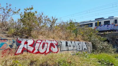 Red and White Stylewriting by Riots and loofya. This Graffiti is located in Palma de Mallorca, Spain and was created in 2019. This Graffiti can be described as Stylewriting and Street Bombing.
