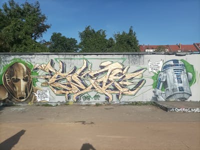 Gold and Grey Stylewriting by Skaf and Fatman. This Graffiti is located in Leipzig, Germany and was created in 2022. This Graffiti can be described as Stylewriting, Characters and Wall of Fame.