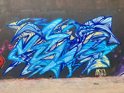 Light Blue and Blue Stylewriting by Amsted. This Graffiti is located in Paris, French Southern Territories and was created in 2022. This Graffiti can be described as Stylewriting and Wall of Fame.