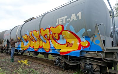 Yellow and Light Blue and Red Stylewriting by S.KAPE289 and Skape289. This Graffiti is located in Germany and was created in 2020. This Graffiti can be described as Stylewriting, Trains, Freights and Atmosphere.