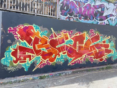 Red and Colorful Stylewriting by OneBlow and TBT crew. This Graffiti is located in London, United Kingdom and was created in 2022. This Graffiti can be described as Stylewriting and Wall of Fame.