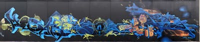 Blue and Orange and Yellow Stylewriting by urine, Hülpman, Köter, mobar, OST, PÜTK and Los Capitanos. This Graffiti is located in Berlin, Germany and was created in 2023. This Graffiti can be described as Stylewriting, Wall of Fame, Characters and Murals.