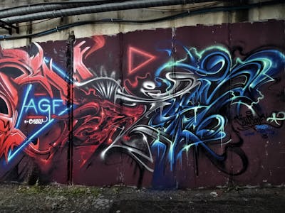 Red and Blue Stylewriting by CETYS.AGF. This Graffiti is located in Banská Bystrica, Slovakia and was created in 2023. This Graffiti can be described as Stylewriting and Abandoned.