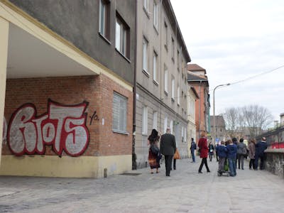 Chrome and Red Street Bombing by Riots. This Graffiti is located in Krakow, Poland and was created in 2010. This Graffiti can be described as Street Bombing, Throw Up and Stylewriting.