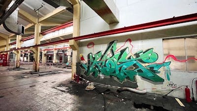 Cyan and Light Green Stylewriting by KonT. This Graffiti is located in Lüdenscheid, Germany and was created in 2022. This Graffiti can be described as Stylewriting, Wall of Fame and Abandoned.