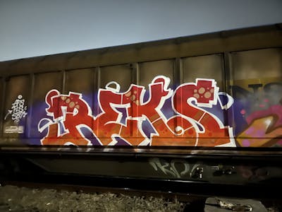Red and White Stylewriting by REKS. This Graffiti is located in Italy and was created in 2024. This Graffiti can be described as Stylewriting, Freights and Trains.