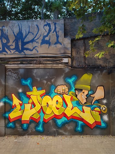 Yellow and Colorful Stylewriting by El Joel. This Graffiti is located in Barcelona, Spain and was created in 2022. This Graffiti can be described as Stylewriting, Characters and Wall of Fame.