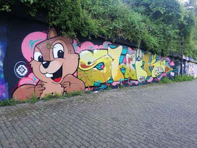 Coralle and Yellow and Colorful Stylewriting by shik. This Graffiti is located in Essen, Germany and was created in 2023. This Graffiti can be described as Stylewriting, Wall of Fame and Characters.