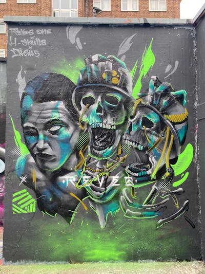 Grey and Light Green Characters by REVES ONE. This Graffiti is located in London, United Kingdom and was created in 2023. This Graffiti can be described as Characters and Wall of Fame.
