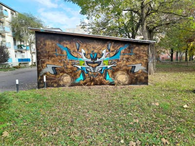 Brown and Cyan Stylewriting by Fuzio. This Graffiti is located in Szolnok, Hungary and was created in 2023. This Graffiti can be described as Stylewriting and Futuristic.