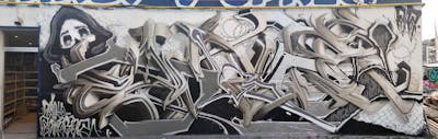 Beige and Grey Stylewriting by Sainter and OKAY. This Graffiti is located in Bratislava, Slovakia and was created in 2022. This Graffiti can be described as Stylewriting, Characters, 3D and Murals.