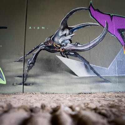 Grey Characters by AIDN and New Cru. This Graffiti is located in Berlin, Germany and was created in 2021. This Graffiti can be described as Characters.