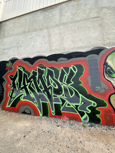 Light Green and Red and Black Stylewriting by Vamos. This Graffiti is located in Valencia, Spain and was created in 2023.