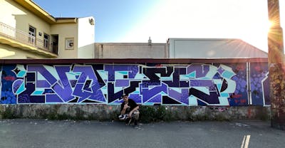 Violet and Light Blue Stylewriting by Notes, BTS and POK. This Graffiti is located in Košice, Slovakia and was created in 2023. This Graffiti can be described as Stylewriting and Atmosphere.