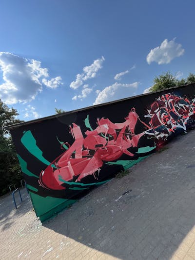 Cyan and Coralle and Red Stylewriting by mobar and OST. This Graffiti is located in Leipzig, Germany and was created in 2023.