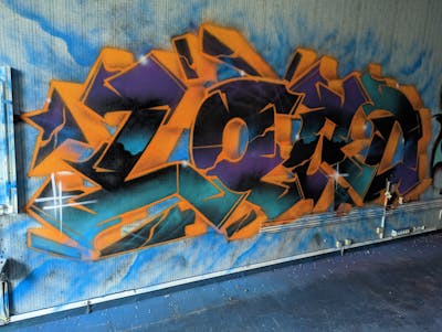 Orange and Violet and Cyan Stylewriting by LORD. This Graffiti is located in Caen, France and was created in 2022. This Graffiti can be described as Stylewriting and Abandoned.