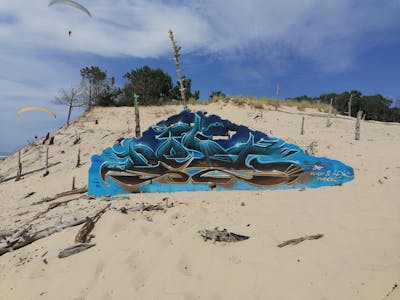 Light Blue and Brown Stylewriting by Dest Jones. This Graffiti is located in Arcachon, France and was created in 2020.