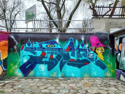 Cyan and Light Green Stylewriting by Fems173. This Graffiti is located in lublin, Poland and was created in 2023. This Graffiti can be described as Stylewriting, Characters and Wall of Fame.